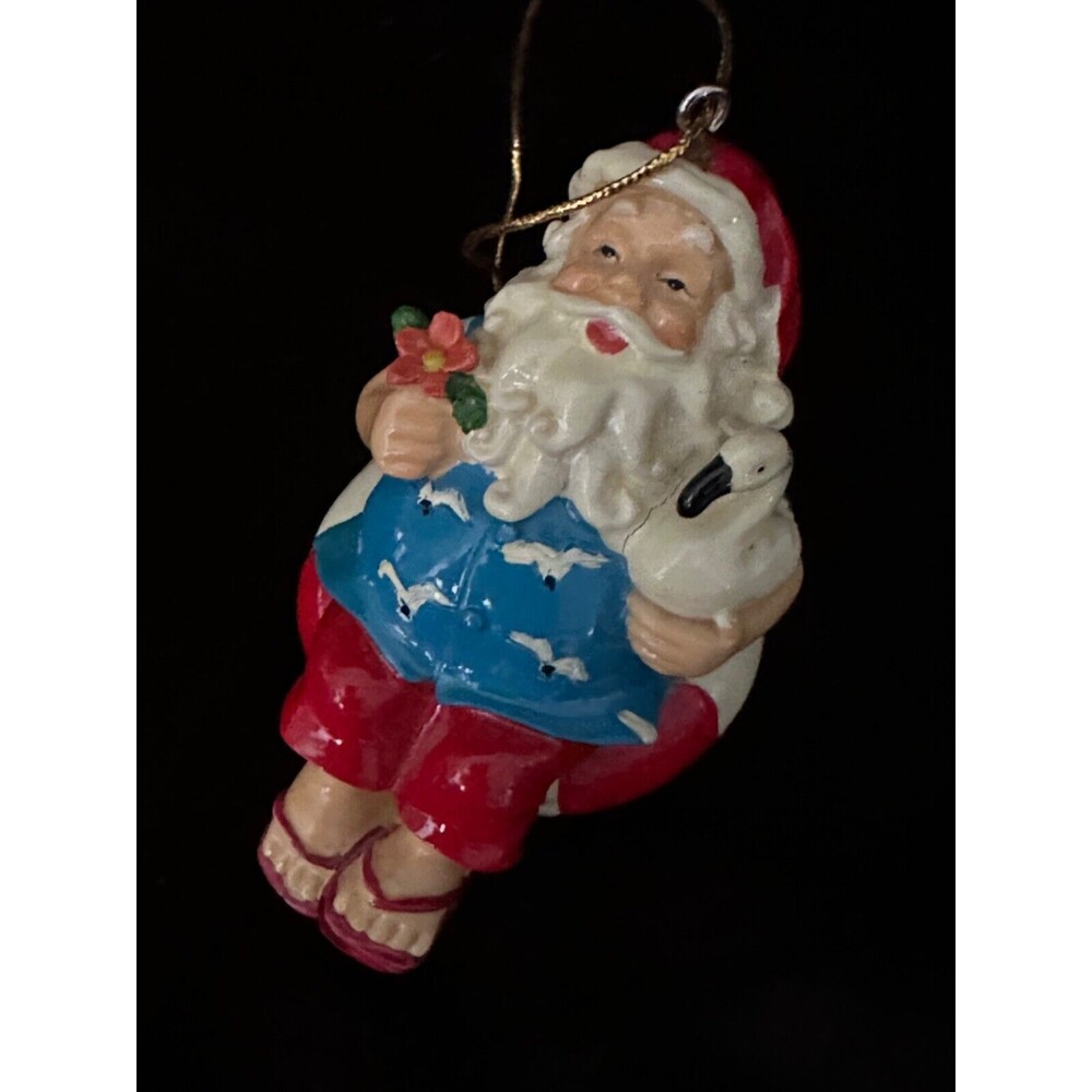Vintage tropical Santa sitting on a float with bird/ flower, Christmas ornament